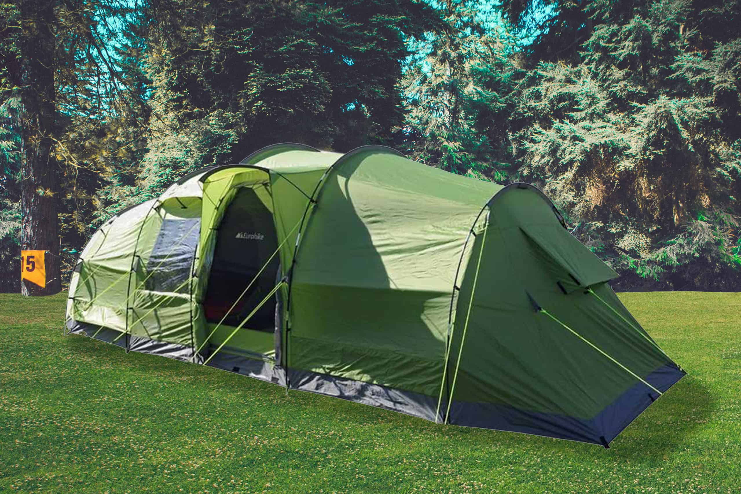 A large green tent pitched in a field.