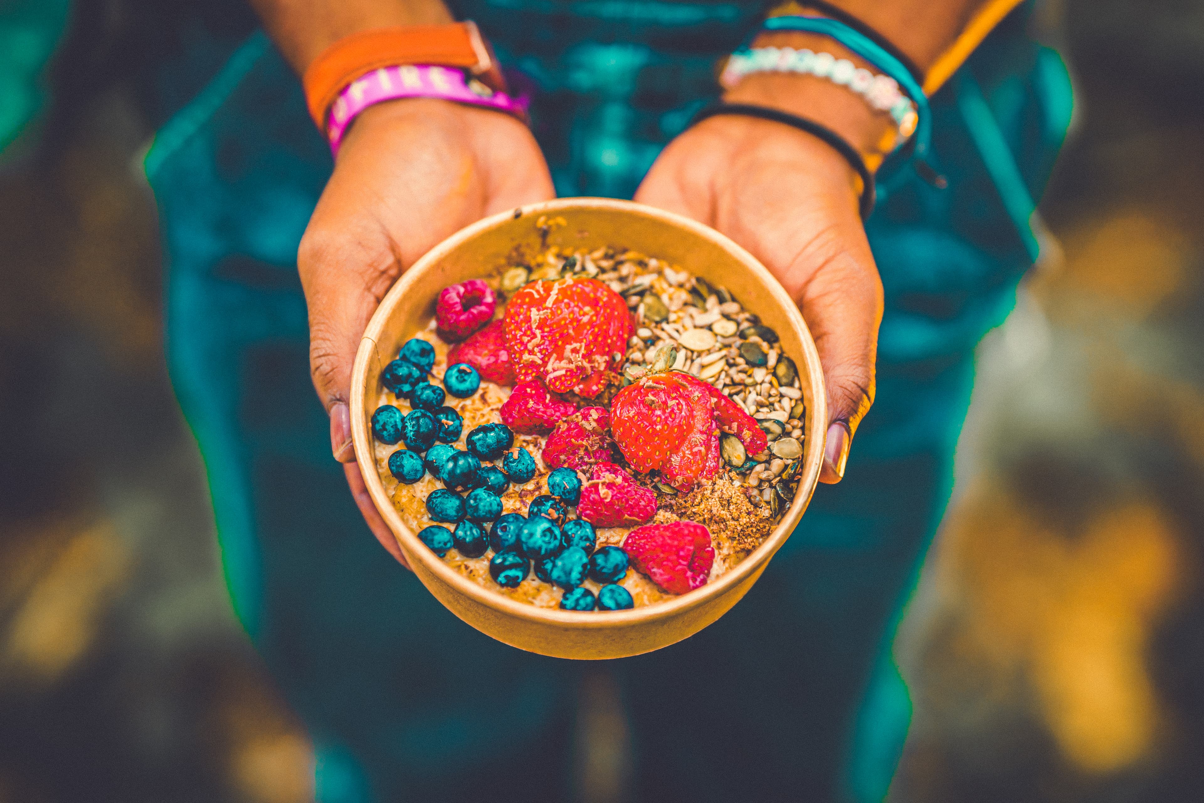 Hands holding a beautiful Acai bowl