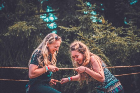 Girls at the pioneering activity at Camp Wildfire. A summer weekend break in a forest near London and Kent. An outdoor woodland retreat featuring adventure activities, live music, DJs, parties and camping. Half summer adventure activity camp, half music festival, for adults only.