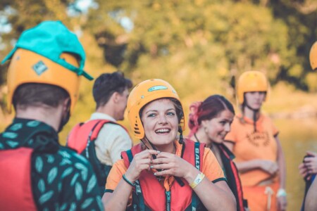 Girl at the Camp Wildfire raft building activity. A summer weekend break in a forest near London and Kent. An outdoor woodland retreat featuring adventure activities, live music, DJs, parties and camping. Half summer adventure activity camp, half music festival, for adults only.