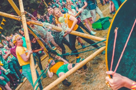 People playing patrol games at Camp Wildfire. A summer weekend break in a forest near London and Kent. An outdoor woodland retreat featuring adventure activities, live music, DJs, parties and camping. Half summer adventure activity camp, half music festival, for adults only.