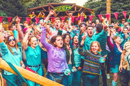 People at the patrol games outside at Camp Wildfire. A summer weekend break in a forest near London and Kent. An outdoor woodland retreat featuring adventure activities, live music, DJs, parties and camping. Half summer adventure activity camp, half music festival, for adults only.