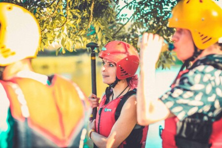 People at raft building activity at Camp Wildfire. A summer weekend break in a forest near London and Kent. An outdoor woodland retreat featuring adventure activities, live music, DJs, parties and camping. Half summer adventure activity camp, half music festival, for adults only.