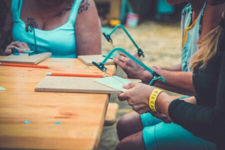 Close up of acrylic jewellery at Camp Wildfire. A summer weekend break in a forest near London and Kent. An outdoor woodland retreat featuring adventure activities, live music, DJs, parties and camping. Half summer adventure activity camp, half music festival, for adults only.